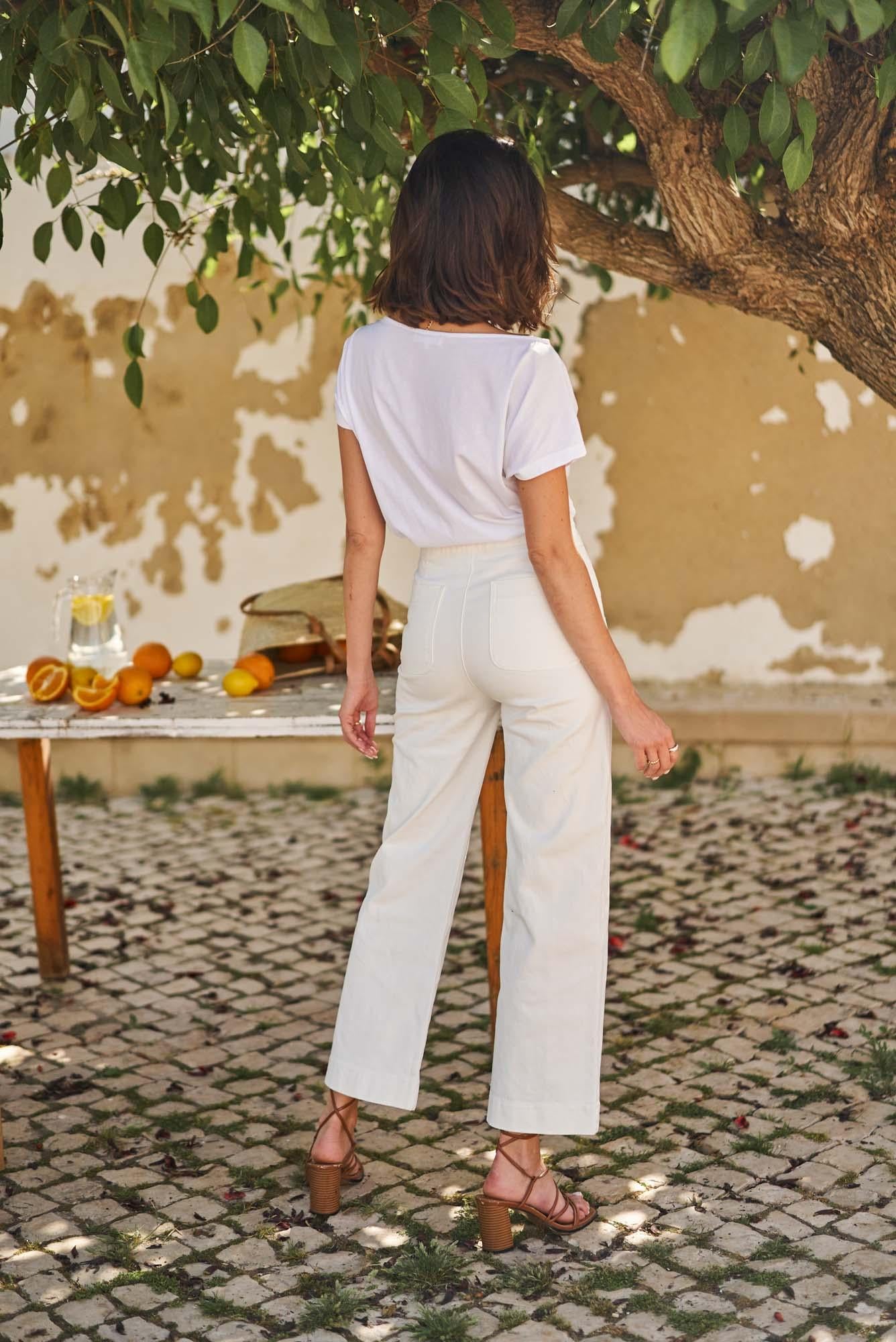 Wide leg white jeans with gold buttons