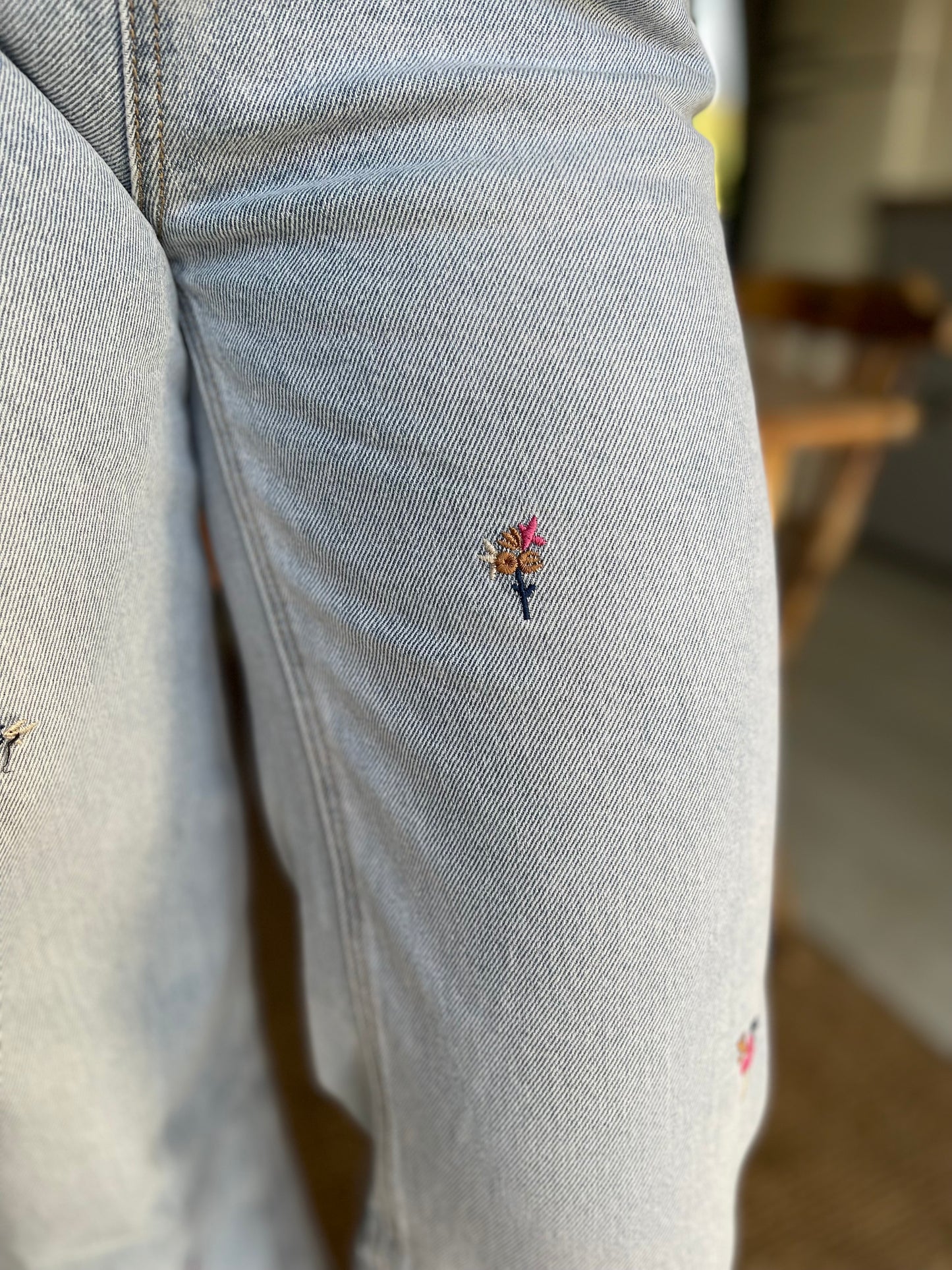 Floral embroidered light wash wide/straight leg jeans