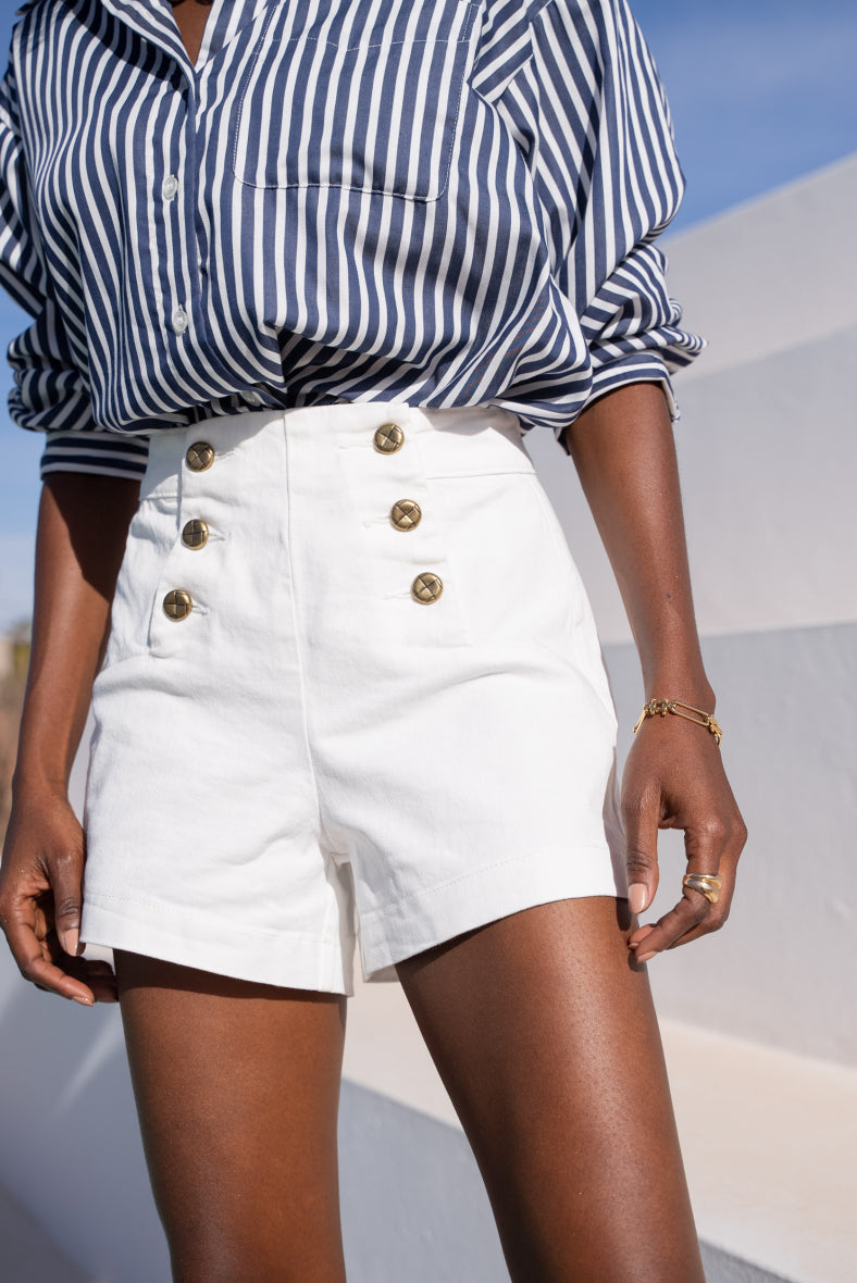 White denim shorts with gold buttons