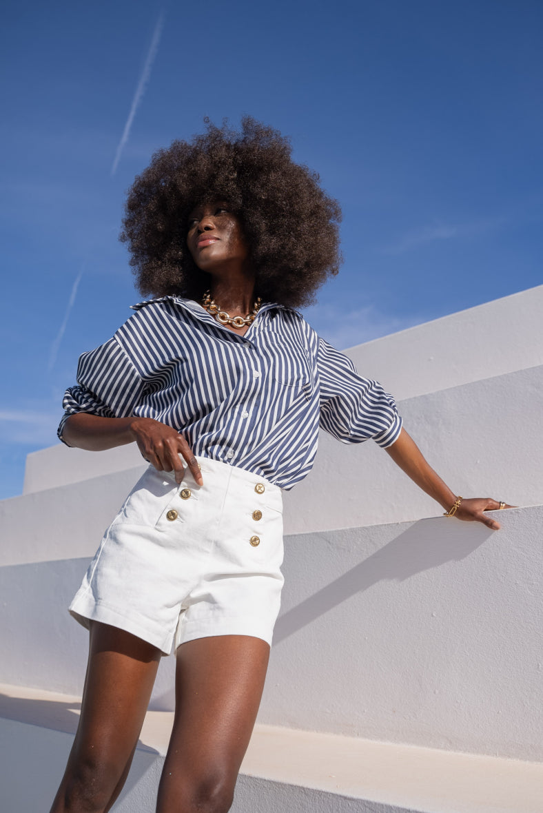 White denim shorts with gold buttons